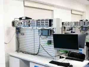 A contemporary office showcasing a server rack and computer workspace, ideal for tech and business settings.